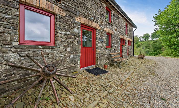The apartment is located on the ground floor of the converted barn in Carmarthenshire, with its own entrance from the courtyard overlooking the large